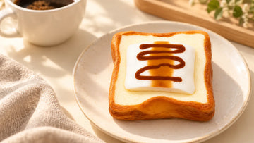 Caramel Marshmallow Toast Squishy on a warm desk, showing layered toast and caramel drizzle