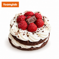 Strawberry chocolate cream cake fidget toy with white frosting swirls, red strawberry decorations and a MILK chocolate-style plaque